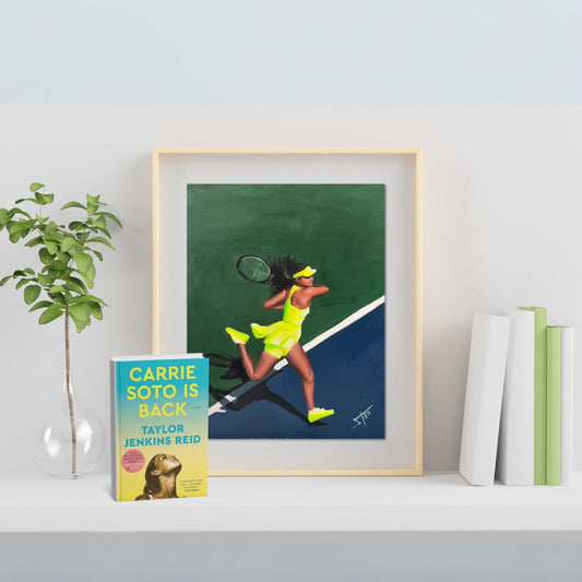 Framed oil painting of a female tennis player in a neon yellow outfit mid-swing on a green and blue court, inspired by the book “Carrie Soto Is Back” by Taylor Jenkins Reid, which is also displayed beside the painting on a white shelf.